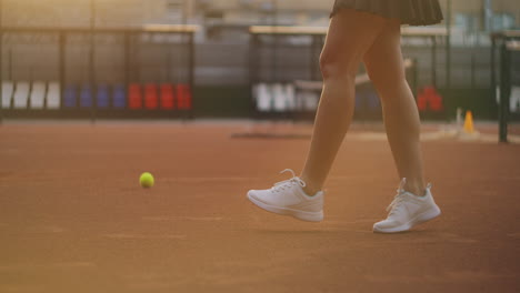 Close-up-of-a-racket-hitting-a-ball-on-a-tennis-court-in-slow-motion